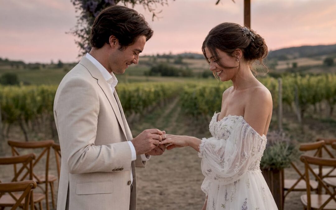 Close-up of couple exchanging wedding bands at ceremony