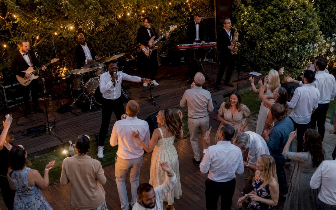 Live band energizing diverse wedding dance floor