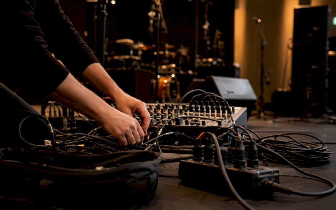 Technician wiring band PA system at soundcheck