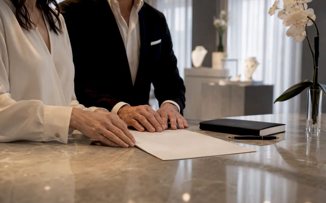 Couple signing wedding band cancellation contract
