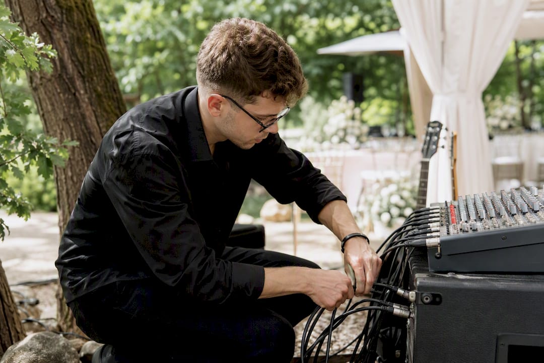 Musician connecting sound cables outdoors