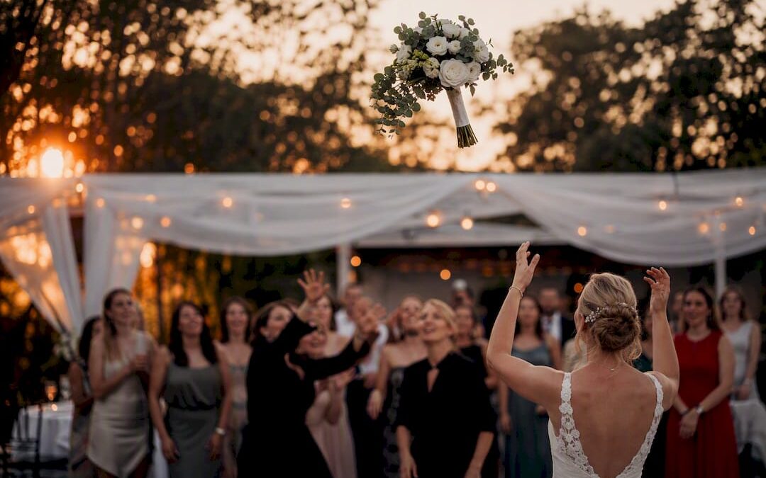 Bridal bouquet mid toss at wedding