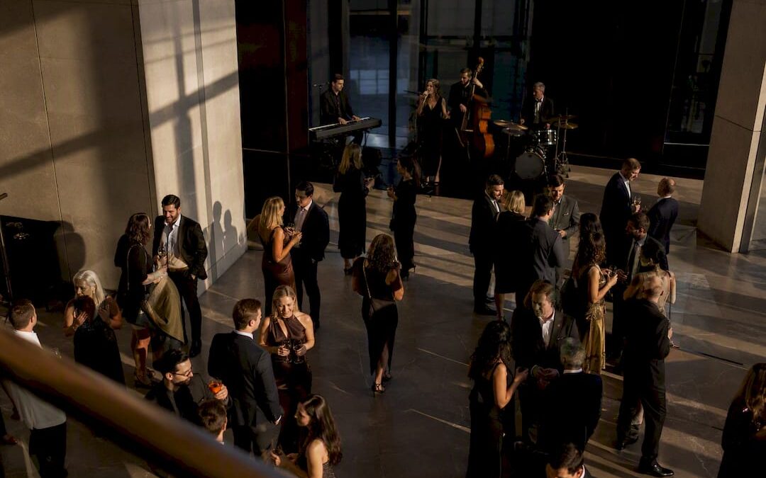 Wedding guests mingling during live cocktail-hour music