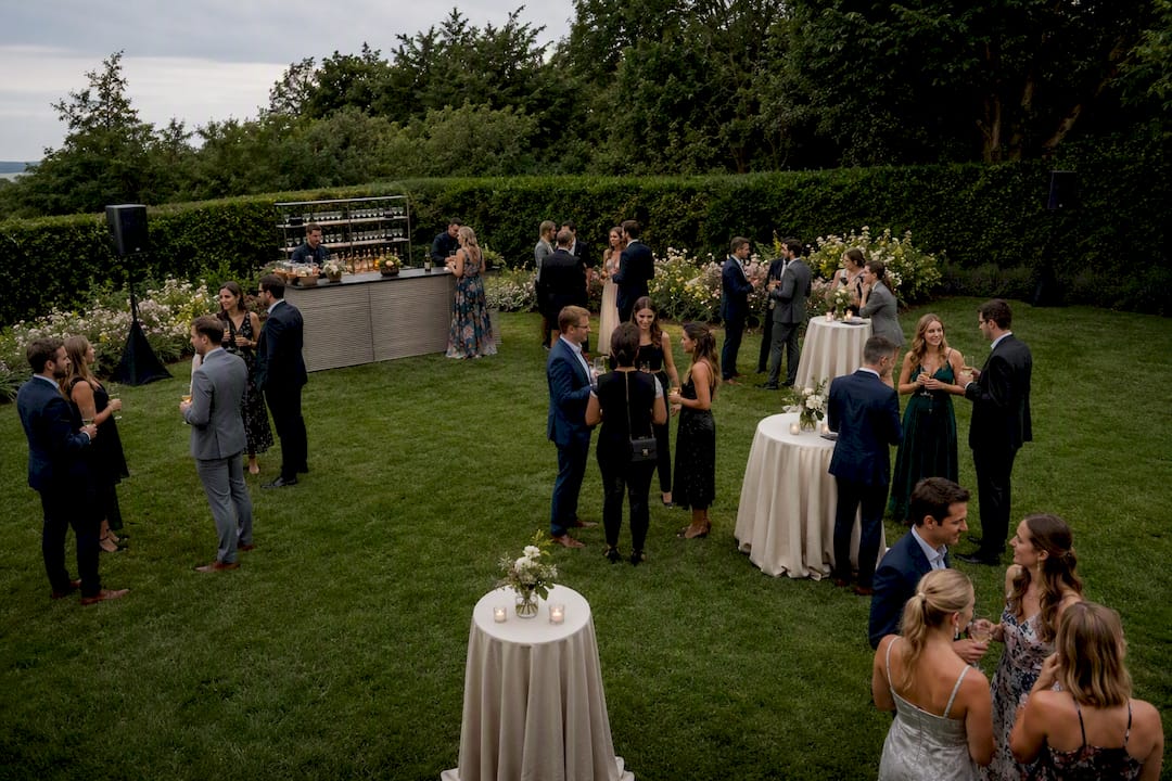 Speakers positioned across an outdoor wedding lawn